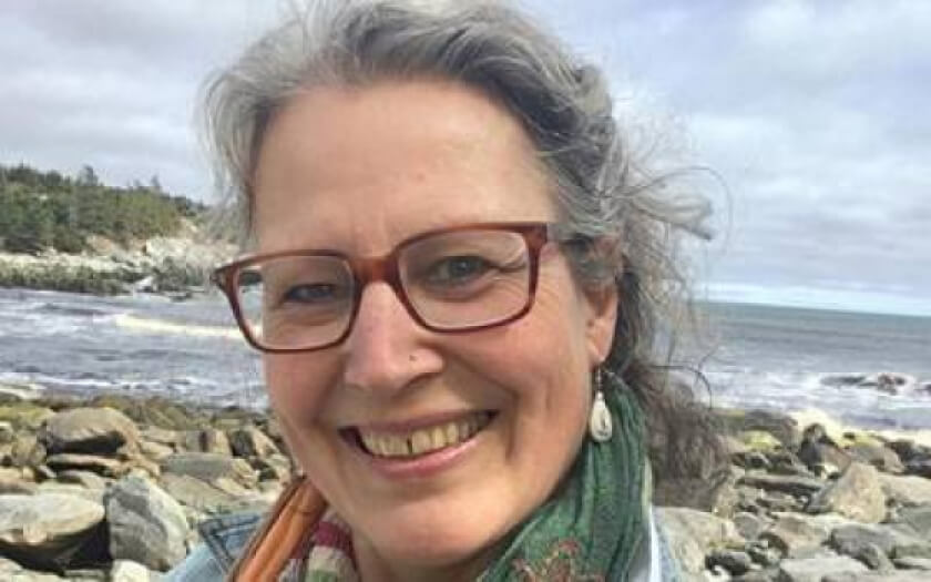 Leigh MacFarlane of The Soap Co of Nova Scotia on a windswept beach.